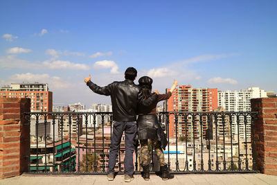 Couple thumbs-up to the impressive city view at the view point of santa lucia hill, santiago, chile