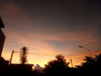 Low angle view of silhouette trees against sky at sunset