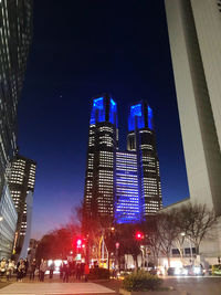 Illuminated modern buildings in city at night