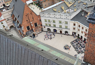 High angle view of people standing on street amidst buildings