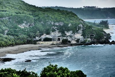 Scenic view of river by mountains against clear sky
