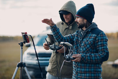 Young man photographing with mobile phone