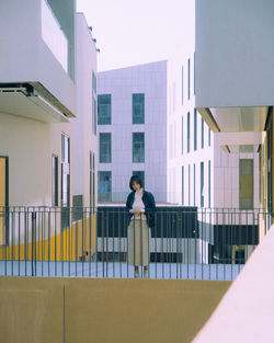 Woman standing in balcony of building