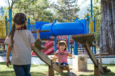 Rear view of woman working in park