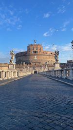 Statue of historic building against blue sky