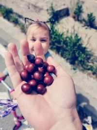 Midsection of boy holding fruit