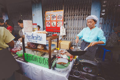 Man for sale at market stall