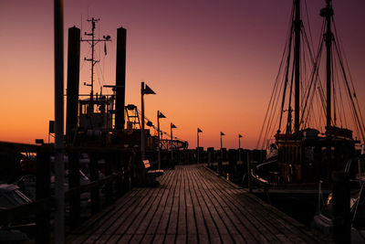 Harbor against clear sky during sunset