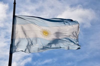 Low angle view of flag against sky