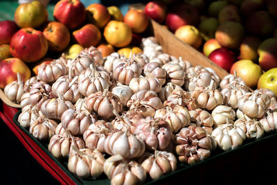 High angle view of garlic and apples at market stall