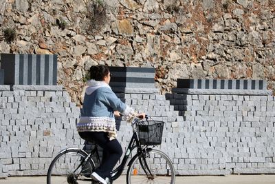 Rear view of woman on bicycle