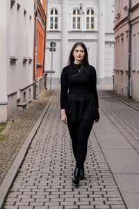 Portrait of young woman walking on street