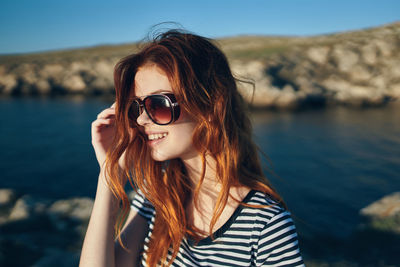 Portrait of young woman wearing sunglasses