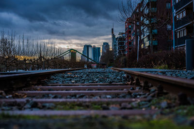 Railroad tracks against sky in city