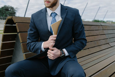 Young man sitting on bench