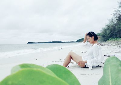 Woman sitting on beach