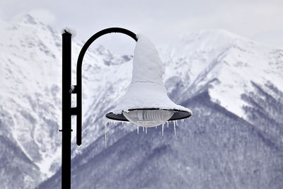 Close-up of snow on mountain against sky