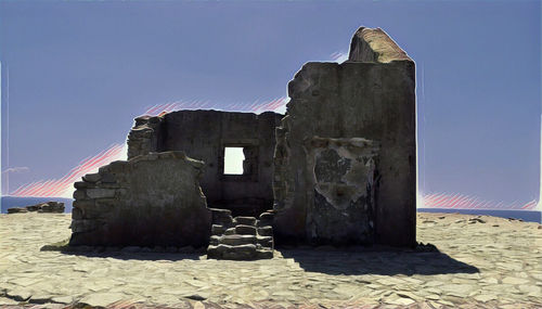 Built structure on sand against clear sky