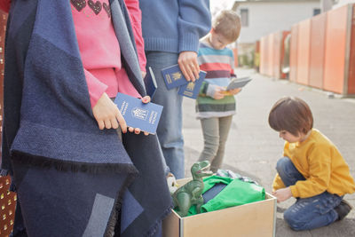 Ukrainian refugees sit near charity center to get humanitarian aid because of russian attack