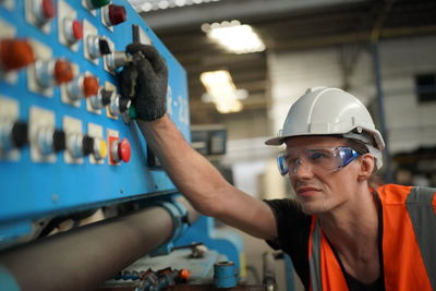 Rear view of man working in factory