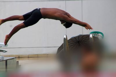 Low section of man exercising on field