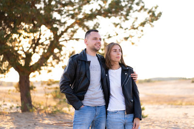 Couple wearing jacket standing outdoors