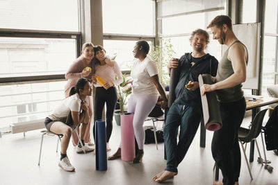 Happy multiracial colleagues enjoying at workplace