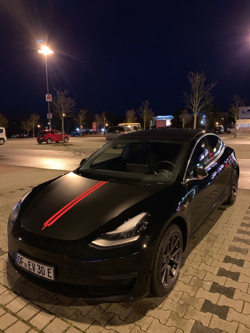 mode of transportation, car, transportation, street, motor vehicle, night, illuminated, city, land vehicle, street light, no people, sky, road, lighting equipment, architecture, outdoors, tree, speed, nature, dusk, paving stone