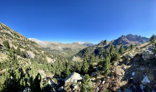 Scenic view of mountains against clear blue sky