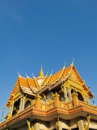 Low angle view of temple building against clear blue sky