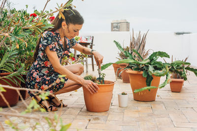 Woman holding potted plant