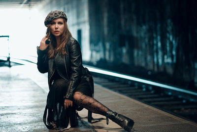 Portrait of young woman sitting outdoors