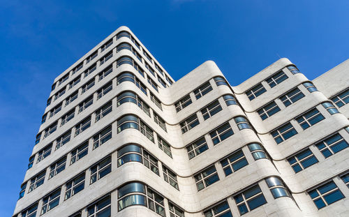 Low angle view of building against clear blue sky