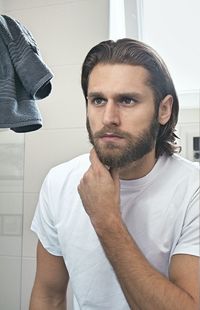 Bearded young man at domestic bathroom