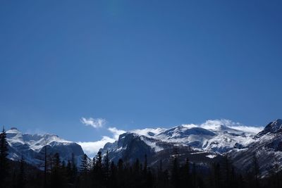 Scenic view of snowcapped mountains against clear blue sky