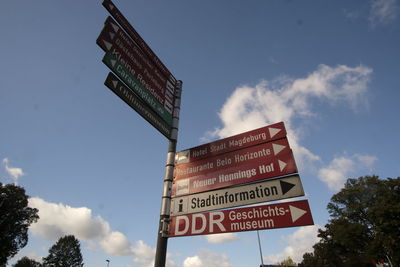 Low angle view of road sign against sky