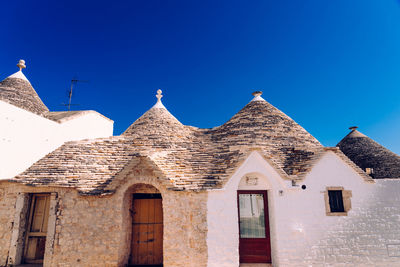 Low angle view of old building against blue sky