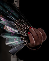 Close up of woman's hand holding a handfan