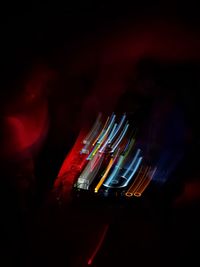 Close-up of illuminated lighting equipment against sky at night