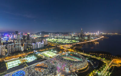 High angle view of illuminated buildings in city at night