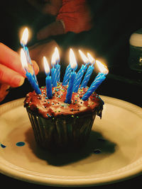 Burning candles on birthday cake