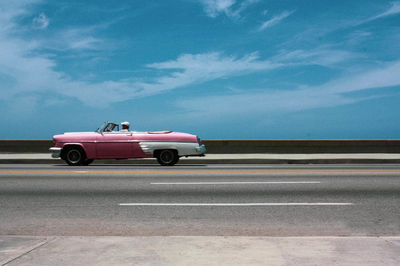 Car on street against blue sky