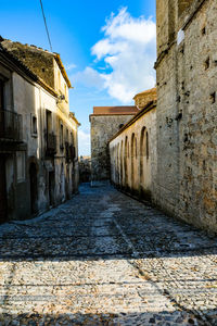 Empty alley amidst buildings in town