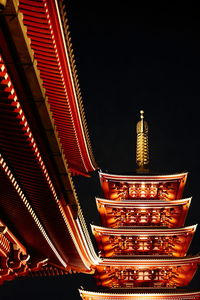 Low angle view of illuminated building against sky at night