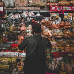 Rear view of man standing at market stall