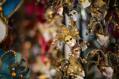 Close-up of small venetian mask hanging for sale