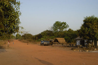 Cars on landscape against clear sky