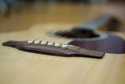 Close-up of guitar on table