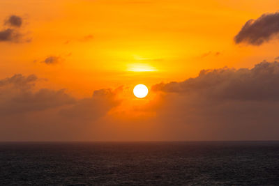 Scenic view of sea against orange sky