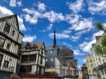 Low angle view of buildings in town against rouen, france